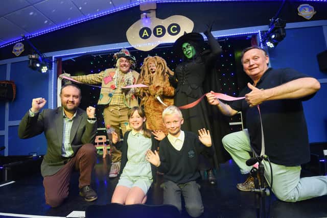 Headteacher Glyn Denton (left) at the opening of Mayfield School's theatre in the summer of 2012, with site manager Denis Askham, pupils Kadie Hayes and Alex Lloyd and visiting members of the cast of The Wizard of Oz..