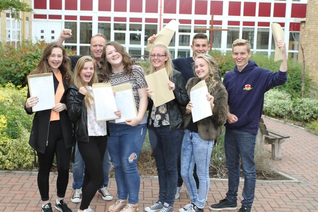 Pupils at St George's School celebrate their GCSE results with headteacher Dan Berry (back left)