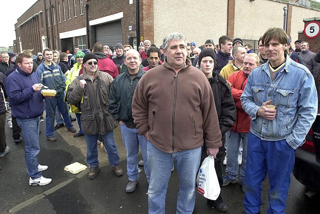 TVR workers spokesman John Redman (centre) outside outside the factory after the breakdown of pay talks in 2004