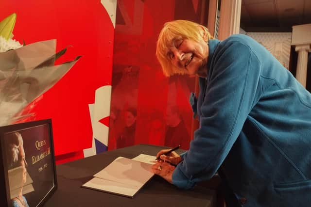 Florence Walsh signs the book of condolence at Madam Tussauds.