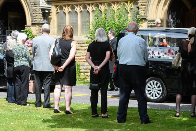 Mourner look on as the hearse carrying the coffin of Spencer Leader, former St Annes British Legion president who raised thousands of pounds for the British Legion Poppy Appeal, arrives as the church. Photo: Kelvin Stuttard