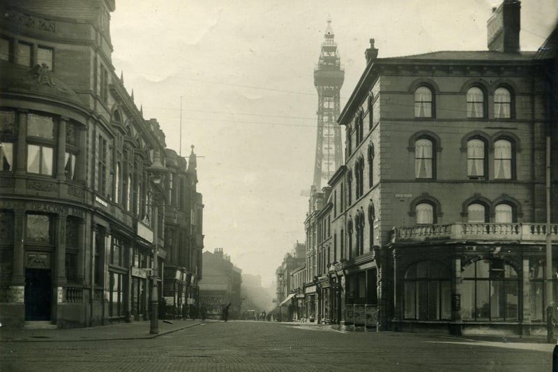 Market Street as seen from Talbot Square appears on early maps. The Clifton Hotel is on the right and beyond the cyclist (with what appears to be a plank across his back ) there is a stall on the corner of the old St John's Market. On the left is the Williams Deacons Bank which is now part of the Town Hall. This was probably 1920s