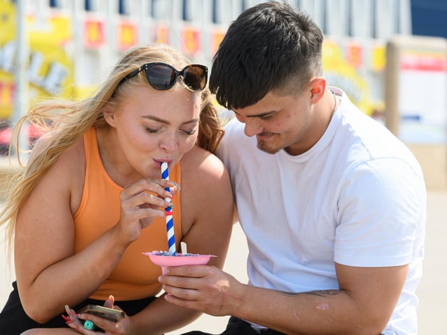 Kira Matthews and Zak Stewart enjoy a snow cone to cool down on Blackpool Promenade. Photo: Kelvin Stuttard