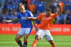 Keshi Anderson tussles for the ball with Rangers midfielder Scott Arfield