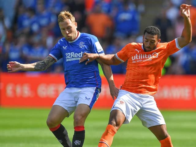 Keshi Anderson tussles for the ball with Rangers midfielder Scott Arfield
