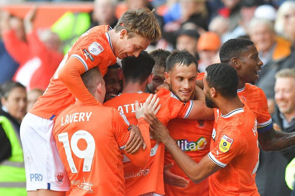 Jerry Yates is mobbed after winning the game for Blackpool late on