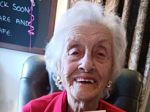 Mary Saville with her 100th birthday card from The King and Queen Consort.