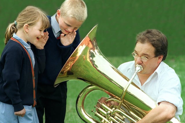 Gavin Woods , from Travelling by Tuba, pictured with Waterloo Primary School pupil  Zoe Cole (6) and Michael Taylor (7)