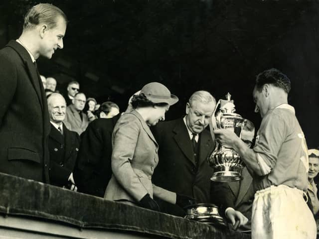 The Queen presents the FA Cup to Blackpool captain Harry Johnston