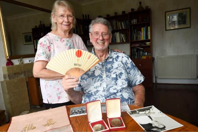 Brian Dickinson pictured with wife Val and fencing medals/memorabilia ahead of the Tokyo Paralympics last year