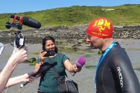 Adam Diver (right) is interviewed after his history-making swim