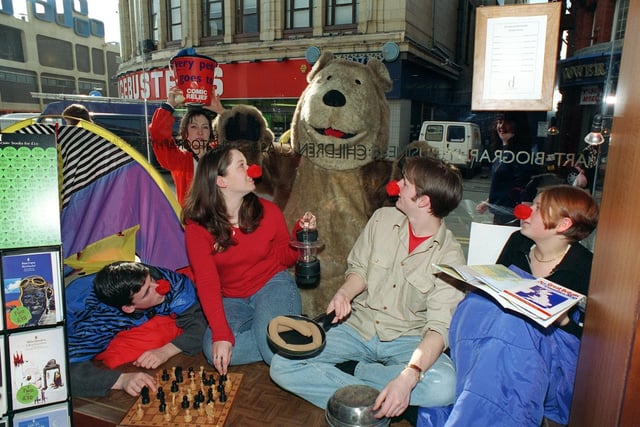 Drama students in the window of Dillons Bookshop, Blackpool, raising money for Comic Relief, 1997. Jake Macfarlane, Rachel Paterson, Craig Morrison and Sarah Moss. Outside, with "Walker Bear" (Kate Adams), is Rebecca Stanbridge.