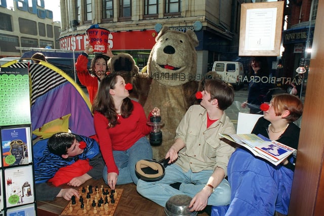 Drama students in the window of Dillons Bookshop, Blackpool, raising money for Comic Relief, 1997. Jake Macfarlane, Rachel Paterson, Craig Morrison and Sarah Moss. Outside, with "Walker Bear"  (Kate Adams), is Rebecca Stanbridge.