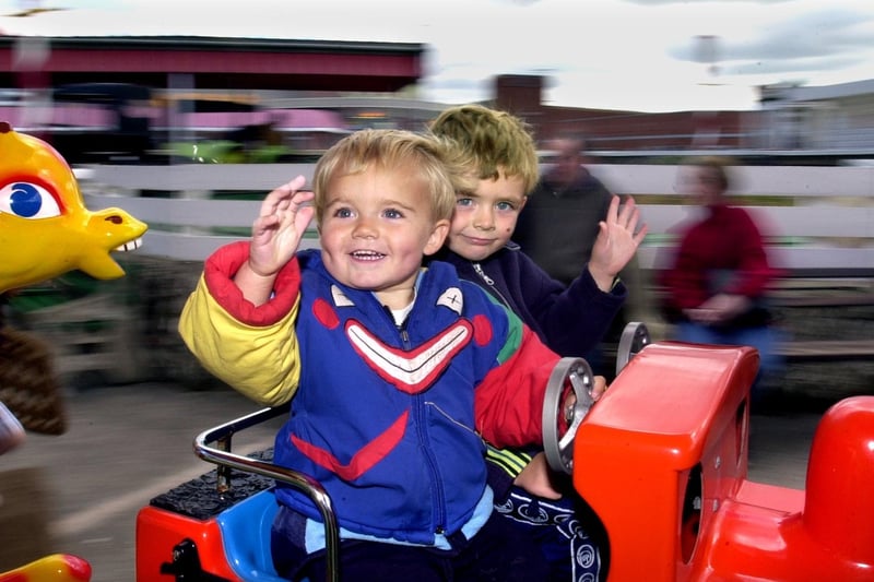 Nathan (left) and Dean Wilson enjoy the merry-go-round in 2000