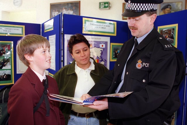 PC Alan Cavanagh talks to Chris Holloway (11) watched on by Karla Andrade police officer from El Salvador who was in Blackpool with a group of police officers to experience policing in the community