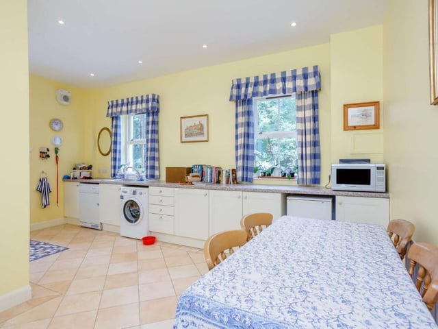 Fitted utility room with door to garden.