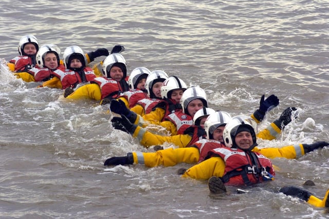 The Morecambe RNLI crew set off on a swim tied together and singing 'Summer Holiday'