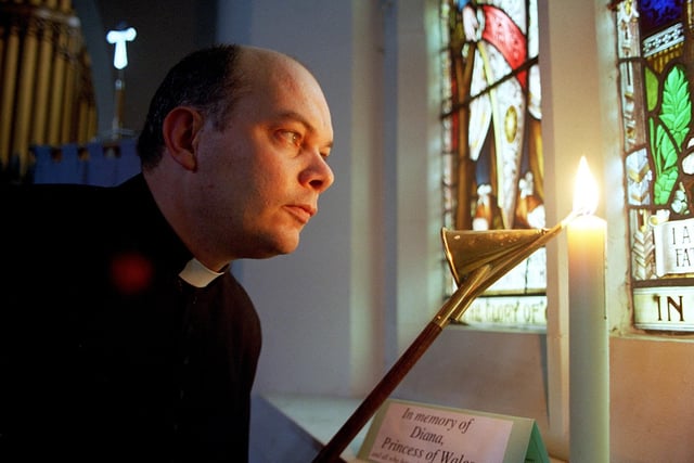 Rev. Michael Manley lighting a Memorial Candle in St John's Church