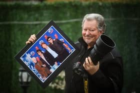 Wayne Paulo with one of his photos, depicting the Rolling Stones