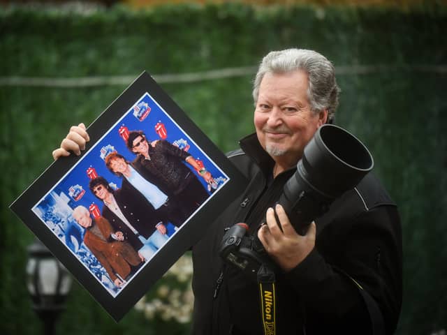 Wayne Paulo with one of his photos, depicting the Rolling Stones