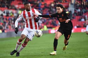 STOKE ON TRENT, ENGLAND - MARCH 05: Tyrese Campbell of Stoke City runs past Reece James of Blackpool during the Sky Bet Championship match between Stoke City and Blackpool at Bet365 Stadium on March 05, 2022 in Stoke on Trent, England. (Photo by Nathan Stirk/Getty Images)
