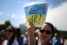 Ukrainians stage a protest outside of the United Nations Office during special session of the UN Human Rights Council on the war in Ukraine, in Geneva on May 12, 2022. - Ukraine slams what it calls the "sheer horror" and "pure evil" being inflicted on their country by Russian forces as the United Nations Human Rights Council holds an extraordinary session on Ukraine. (Photo by Fabrice COFFRINI / AFP) (Photo by FABRICE COFFRINI/AFP via Getty Images)