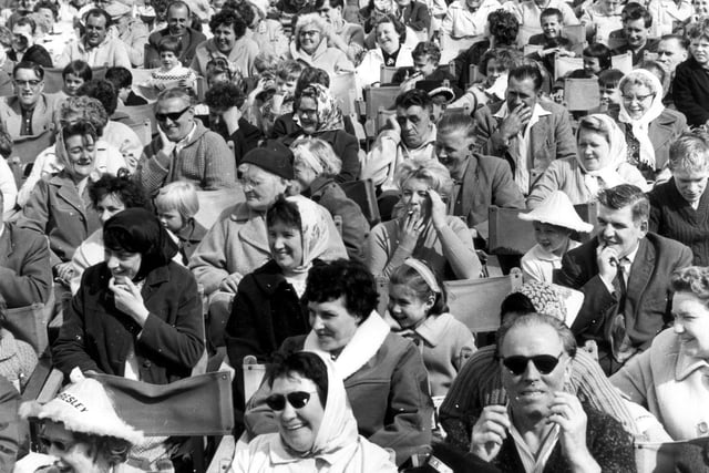 Something is holding the interest of the hundreds of holidaymakers onBlackpool Beach - try counting the number of headscarfs! This is dates 1950s