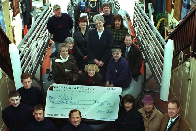 Margaret Bryant from Blackpool Ladies Lifeboat Guild, receives a cheque for £5000 raised by staff from Bradford and Bingley, 1998
She is pictured with crew members from the RNLI