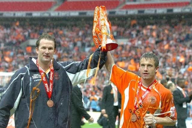 Special moment - Simon Grayson and Keigan Parker hold the trophy aloft after the Wembley play-off final against Yeovil. Parker dons the 2007-08 kit sponsored by Floors2Go