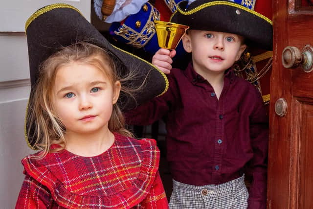 Kila Redfearn's grandchildren, George and Lily, get into the spirit of her new role as town crier for Lytham. Picture by Elizabeth Gomm