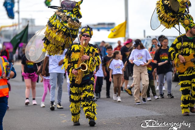 A saxophonist gets into the swing of things in the carnival procession