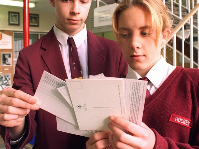 Rachel Middlemas and Greg Whitam looking at some of the sex education postcards, sent to their school, Montgomery High School in 1996