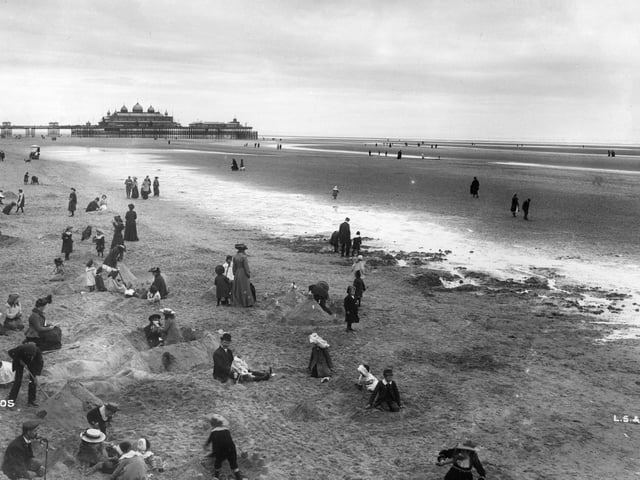This pictures is from a completely different time, but still resonates today. Families enjoy the beach at Blackpool with the North Pier visible in the background in 1903