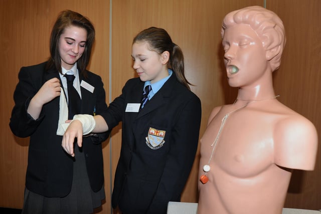 Pupils from Collegiate High and Bispham High Schools took part in a day of bonding exercises and classes prior to the two schools' merger. Courtney McDonald from Bispham High (left) has an 'injured' arm tended to by Collegiate pupil Chelsea Dowling