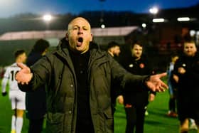 Adam Murray leads the supporters' singalong after the victory at Scarborough Picture: STEVE MCLELLAN