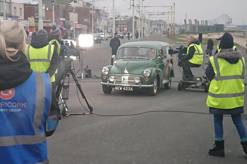Roy Cropper driving his Morris Minor Traveller whilst filming on the promenade