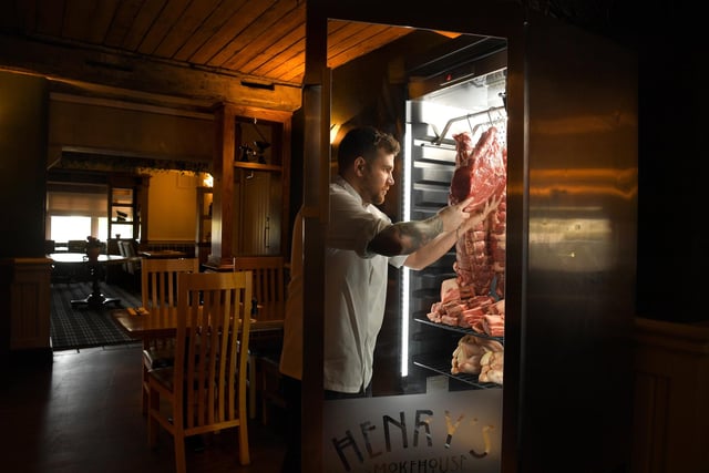 Andrew Bennett, chef de cuisine at Henry's Steakhouse, Kirkham, checks the meat in the dry aging cabinet
