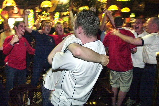 England supporters in The Star at Blackpool Pleasure Beach, embrace at the final whistle back in 2002
