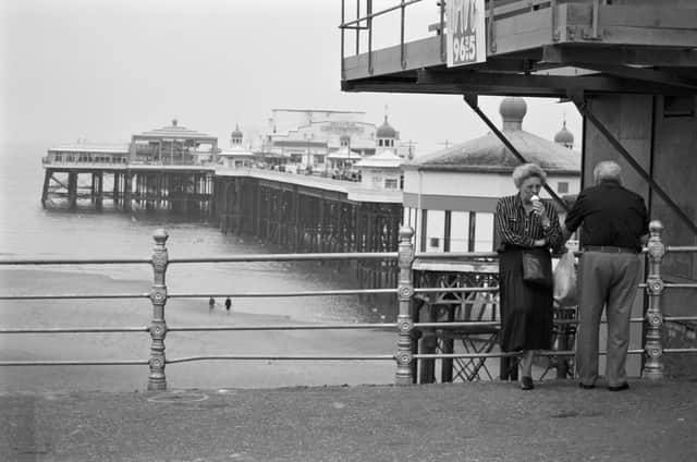 This was the end of September in 1998 as the season was coming to an end. An elderly couple are pictured by the pier enjoying an ice-cream - an absolute necessity when you're on holiday in Blackpool, even under gloomy skies