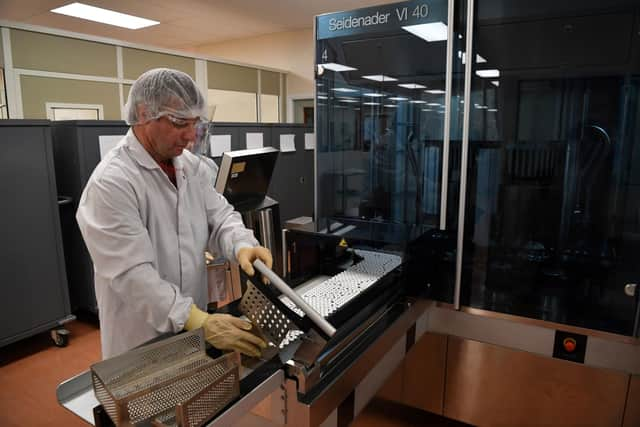 Workers perform last minute quality testing of the 'fill and finish' stage of the manufacturing process of Covid-19 vaccines.
The pandemic is still affecting the economy with latest figures saying that the ending of the Government’s Covid-19 Test and Trace programme and lower vaccination activity caused a fall in growth