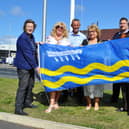 St Annes town mayor Karen Harrison (centre) and deputy mayor Cheryl Little raising the town flag with councillors Carole Lanyon, Angela Jacques and Gavin Harrison along with Lidl area manager Neil Hisely and the Lidl store deputy manager Stuart Marlow.