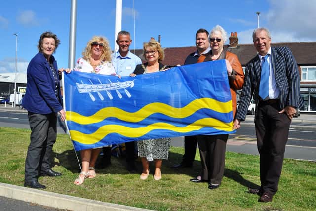St Annes town mayor Karen Harrison (centre) and deputy mayor Cheryl Little raising the town flag with councillors Carole Lanyon, Angela Jacques and Gavin Harrison along with Lidl area manager Neil Hisely and the Lidl store deputy manager Stuart Marlow.