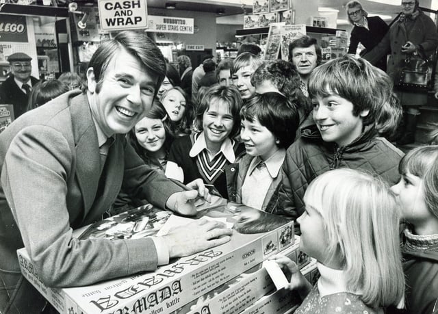 Television presenter Leslie Crowther of Crackerjack fame, pictured at Redgates store, Sheffield, surrounded by a crowd of smiling youngsters, on November 22, 1975