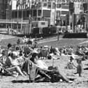 It must have been a miserable summer because the caption on the back of this photo reads:  'Shock appearance of the sun sent youngsters of all ages on to the beach at Blackpool, scratching their heads and trying to remember how to tackle a real summer. Swim suits came out, buckets and spades were dusted down and, for the first time this year, sandcastles proliferated along the shore, with the occasional father buried beneath them'