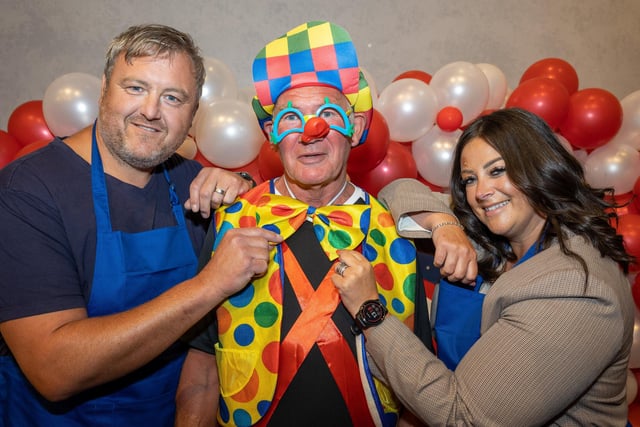 Blackpool lottery winners Andrew Cunliffe and Natalie Cunliffe with performer Kevin Jones.