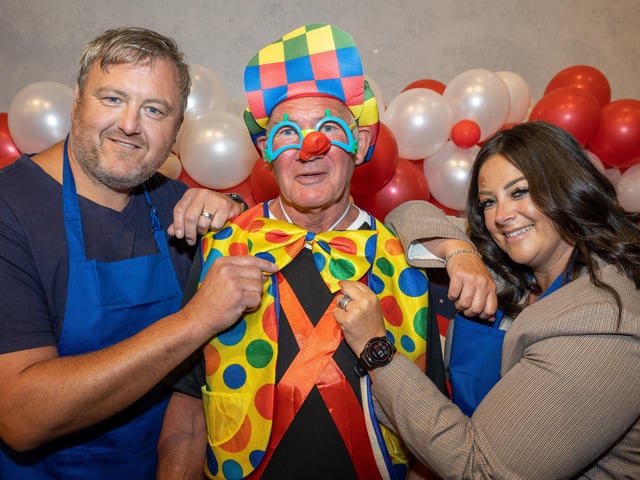 Blackpool lottery winners Andrew Cunliffe and Natalie Cunliffe with performer Kevin Jones.