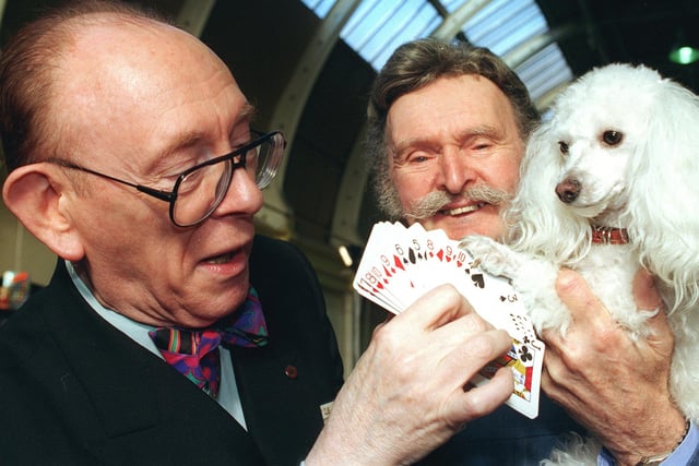 Mark Raffles and his dog Twinkle pick a card from Ali Bongo (left) during the international magic convention at the Winter Gardens, Church Street, Blackpool