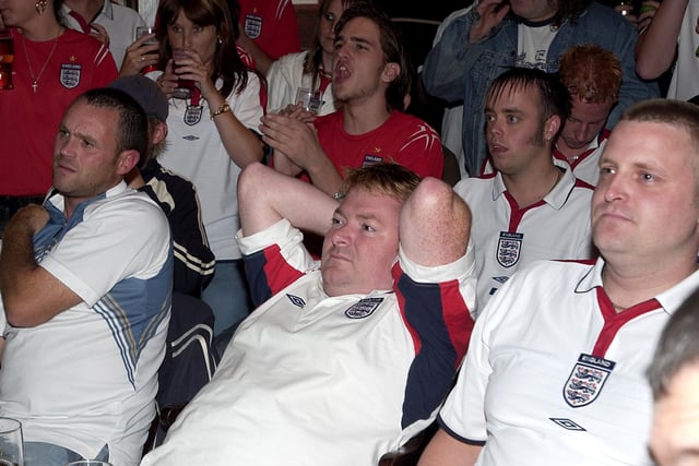 Devastated England fans watch their team crash out of Euro 2004 in their game against Portugal