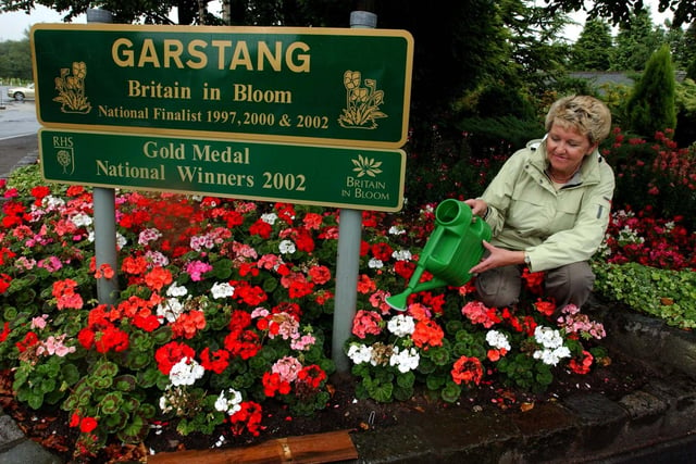 Norah Hoyles watering the flowers for the Garstang entry in Britain in Bloom