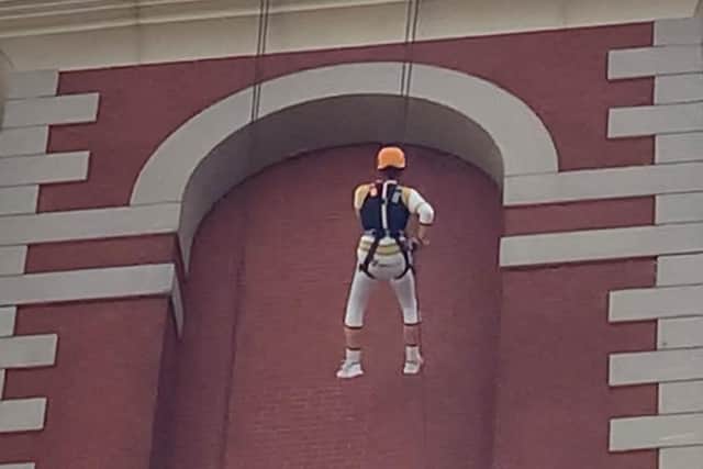 Keith Walsh, dressed as a Power Ranger, abseiling down Barton Tower at the Trafford Centre.